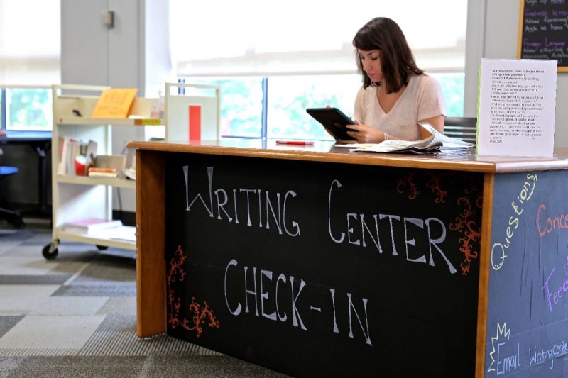 Writing Center Check in table with a woman sitting behind the desk.