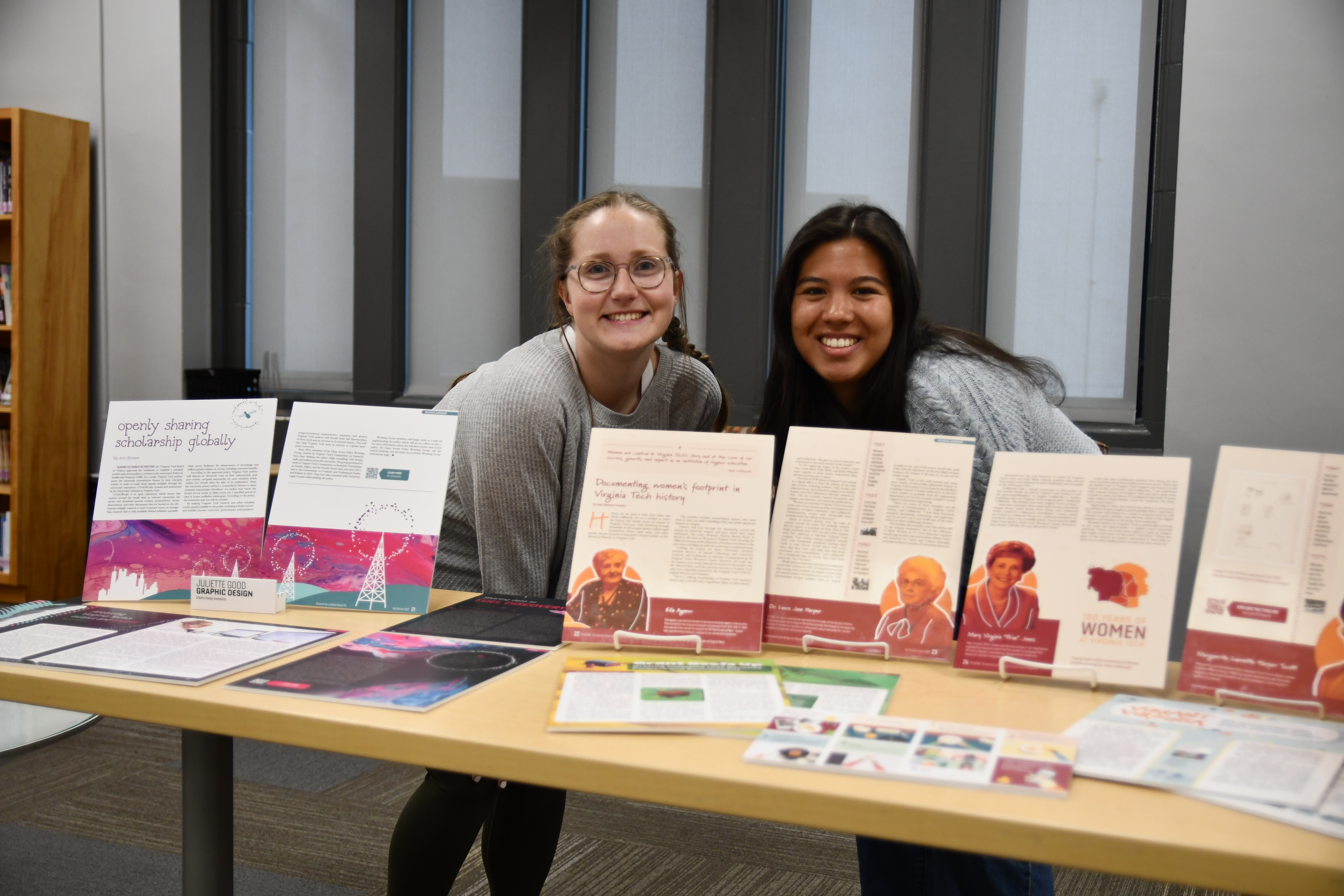 two students smiling with graphic design art