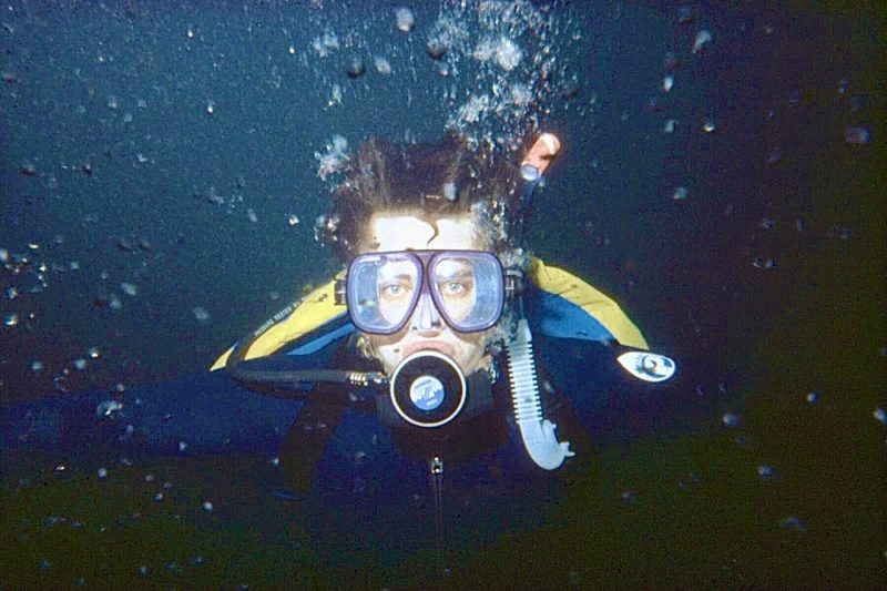 Book author Donald Orth is pictured looking at the camera underwater in scuba gear surrounded by air bubbles.