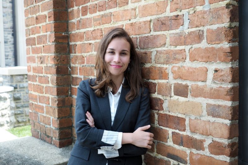 Headshot of Jessica Taylor leaning against a brick wall