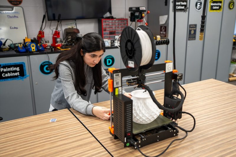 Ayda Haydarpour works on a 3D printer in the Prototyping studio in Newman Library. Haydarpour is a computer science student in the College of Engineering and was part of the Afghan Girls Robotics Team, which is the focus of a recent movie, "Rule Breakers."