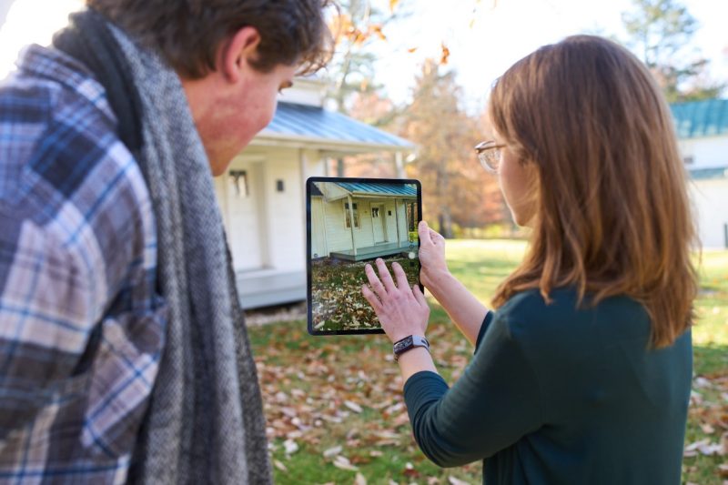 Jessica Taylor, an assistant professor of oral and public history at Virginia Tech, uses an iPad to help bring the history of the Fraction Family House to life.