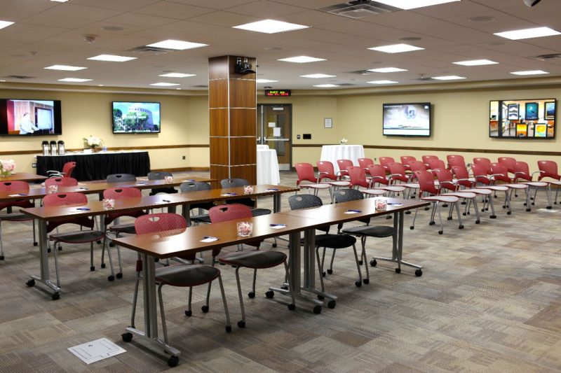 Room set up with rows of tables and chairs.